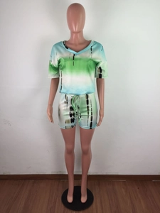 Detail of blue and green tie-dye two-piece set featuring drawstring shorts and v-neck top