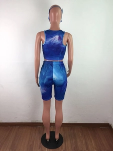 Rear view of tie-dye sports set featuring crop tank top, biker shorts, and matching headband