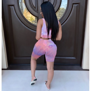 Back view of pink and purple tie-dye two-piece set with crop top and biker shorts