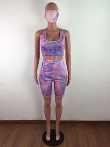 Detail of pink tie-dye three-piece set with crop top, biker shorts and matching face mask