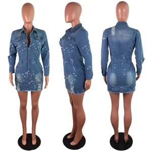 Detail of distressed denim dress with paint splatter pattern and button-down front closure