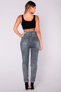 Dettaglio dei jeans skinny grigi lavaggio acido a vita alta con tasche posteriori