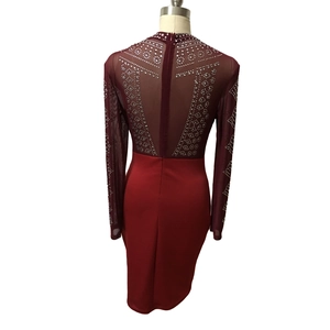 Close-up of burgundy bodycon dress back featuring sheer mesh and silver rhinestone patterns