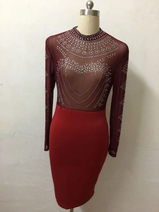 Detailed view of rhinestone heart patterns on the burgundy sheer mesh sleeve and neck