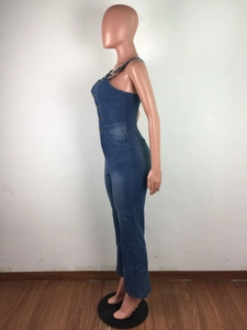 Detailansicht eines Denim-Jumpsuits mit seitlichen Metallknöpfen und Slim-Fit-Ausstülpung