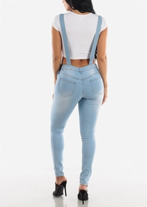 Slim fit light blue denim overalls for women with distressed details and back pocket view