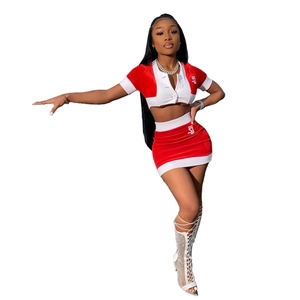Detail of red velvet crop top and mini skirt set with white ribbed trim and button-up V-neck