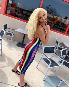 Detail of a rainbow striped bodycon dress with slim straps and an open back design