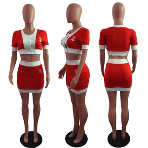 Detail view of red and white two-piece crop top and mini skirt set with logo prints