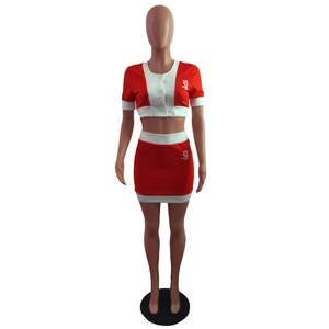 Detailed close-up of a red and white contrast short sleeve crop top and mini skirt set