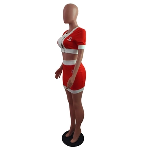 Detail of red and white two-piece crop top and high-waisted mini skirt set with logo print