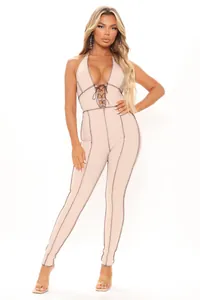 Detail of apricot ribbed halter jumpsuit with deep V-neckline and lace-up front detail