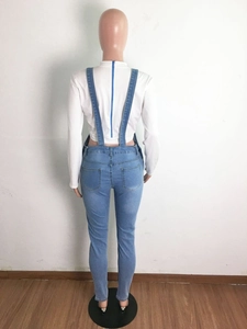 Rear view of slim fit blue denim overalls with a white long sleeve top and blue back zipper