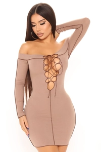 Detail of lace-up cutout and vertical ribbed knit texture on the slim fit mini dress