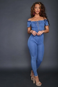 Close-up of blue denim off-shoulder jumpsuit with lace-up detail and slim fit design