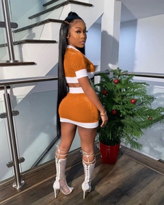 Detail of orange and white contrast stitch two-piece skirt set with cropped top