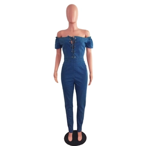 Detail of off-shoulder denim jumpsuit featuring metal eyelets and cross-tie lace-up front
