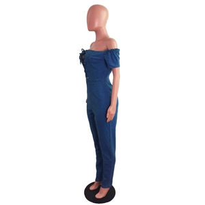 Side view of blue off-shoulder denim jumpsuit with lace-up eyelet detail on the front