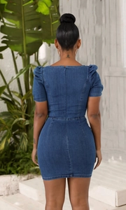 Rear view of a slim fit blue denim mini dress featuring puff sleeves and a back zipper
