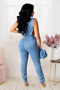 Slim fit light blue denim jumpsuit with an open back design and washed finish detail