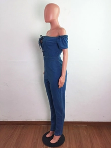 Close-up of off-shoulder denim jumpsuit with lace-up detail and ruffled neckline