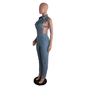 Side view of blue denim jumpsuit featuring waist cut-outs and lace-up strap details