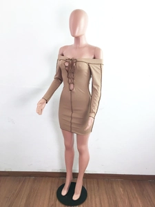 Detail of khaki ribbed knit mini dress featuring long sleeves and lace-up neck design