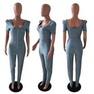 Three-way view of light blue denim jumpsuit with puff sleeves and front zipper detail