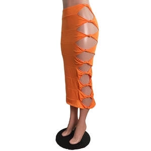 Detail of orange midi skirt featuring side cut-out design and stylish knotted fabric