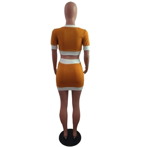 Rear view detail of a two-piece crop top and mini skirt set with white contrast trim