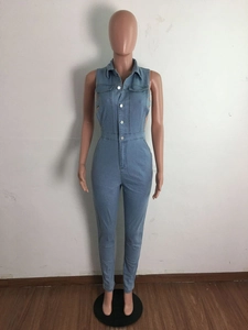 Detail view of light blue denim sleeveless jumpsuit with metal buttons and slim waist design