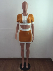 Front detail of crop top and mini skirt set with button closure and logo graphics