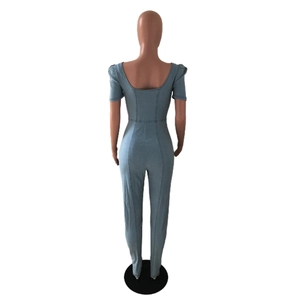 Slim fit light blue denim jumpsuit featuring puff short sleeves and a deep U-shaped back