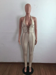 Detail of beige ribbed halter neck jumpsuit with deep V-neck and contrast piping
