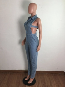 Detail of light blue denim jumpsuit featuring side hollow-out lace-up design and metal buttons