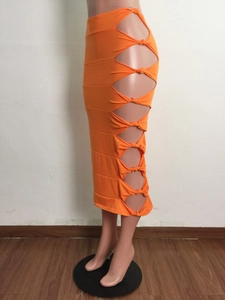 Detailed side view of bright orange bodycon skirt featuring side cutout and knot details