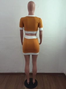 Rear view of ginger yellow knit two-piece set with white contrast trim on back