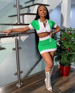 Detail of trendy two-piece set featuring vibrant green contrast stitching and V-neck top