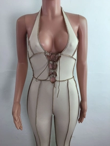 Detail of beige ribbed halter bodysuit with deep V-neck and brown contrast stitching