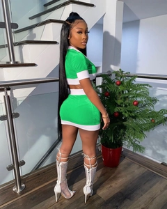Detail of green two-piece set featuring contrast white stripes and cropped short sleeve top