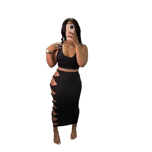 Close-up of black two-piece set featuring hollow cut-out details and side knotting on the skirt
