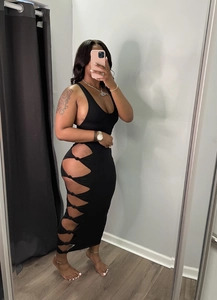Detail of black rib-knit maxi dress with side cut-outs and knot ties for a sexy style