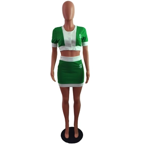 Detail of green and white color-block short sleeve crop top and matching mini skirt set