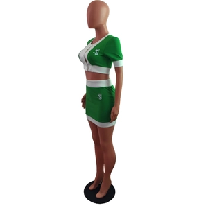 Side view of green and white color-block two-piece set with V-neck top and mini skirt