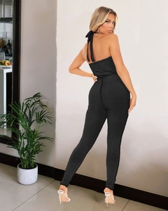 Detail of black halter backless jumpsuit in ribbed knit fabric from a back view