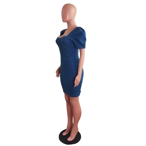 Detail of slim fit dark blue denim dress featuring puff sleeves and button-up front