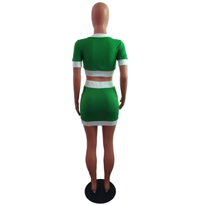 Back view of a green two-piece skirt set with white contrast trim and crop top