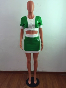 Detail of green contrast crop top and skirt set with SJ logo and white polo collar