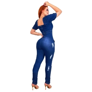 Slim fit dark blue denim jumpsuit with backless square neck and distressed leg details