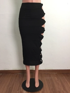 Detail view of the high-waisted black pencil skirt with side cut-outs and ruffled edges